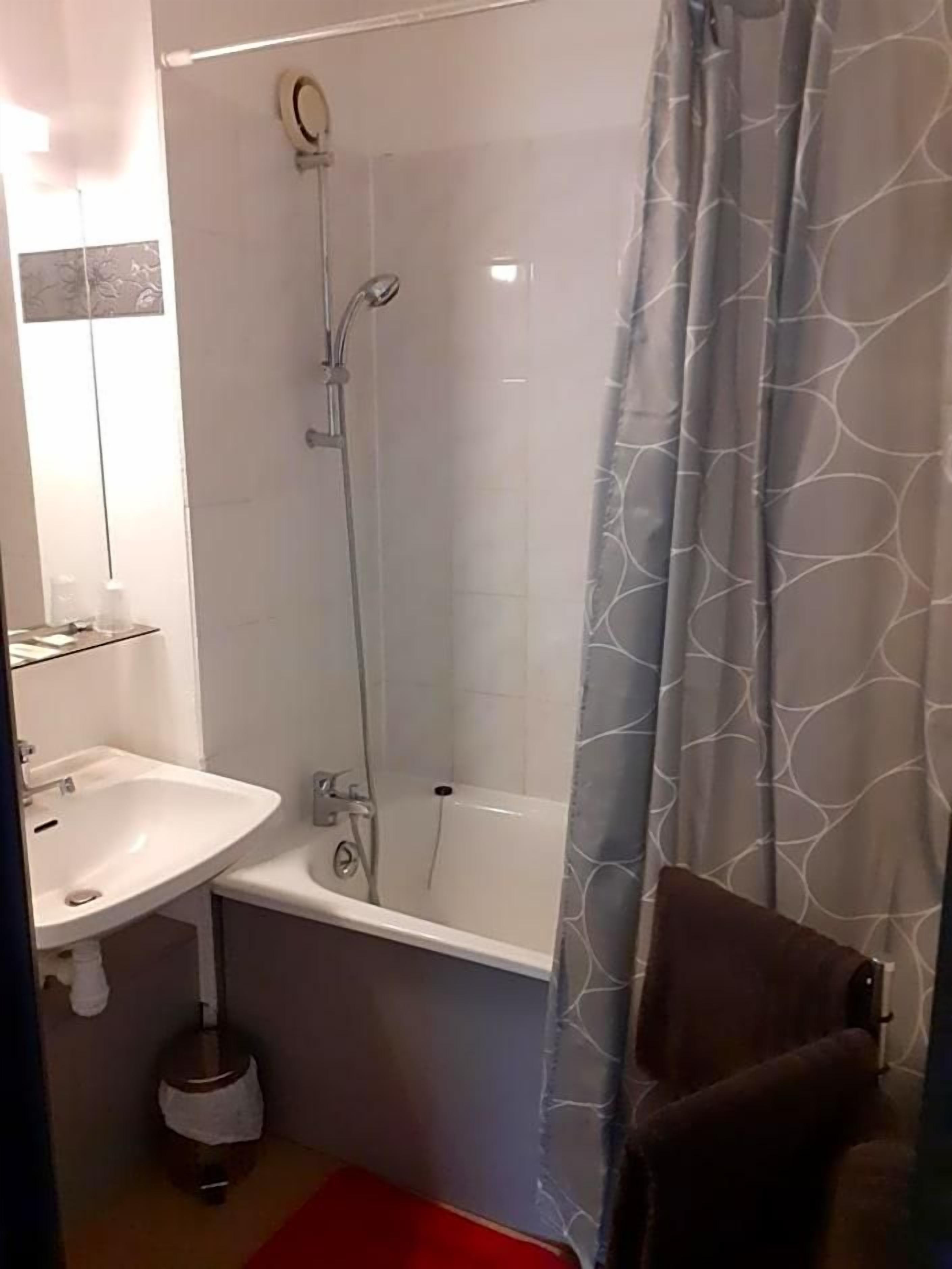 Une salle de bain avec une douche, un lavabo et des toilettes.