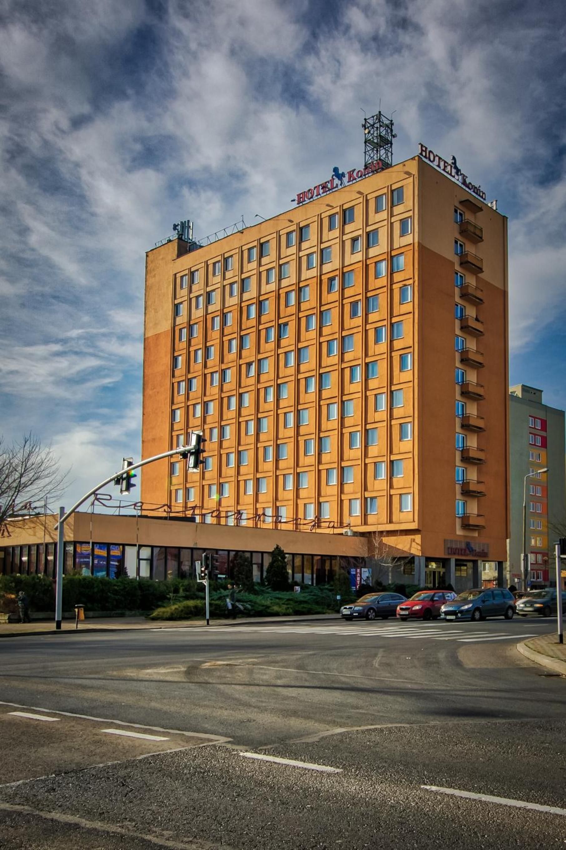 A multi-story hotel with a uniform facade, numerous windows, and a flat roof.