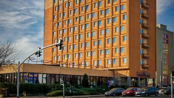 A multi-story hotel with a uniform facade, numerous windows, and a flat roof.