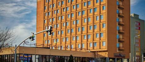 A multi-story hotel with a uniform facade, numerous windows, and a flat roof.