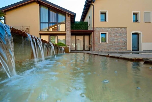 A modern building with a water feature in front.
