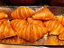A tray of golden-brown croissants.