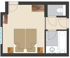 Plano de planta que muestra dos dormitorios, un baño, una cocina y una sala de estar.