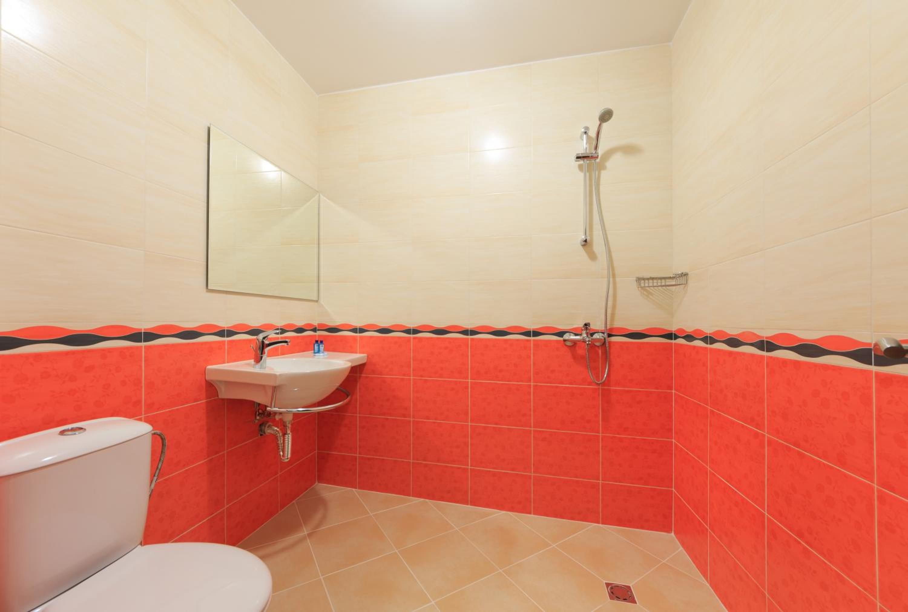 Un baño con inodoro, lavabo y ducha.