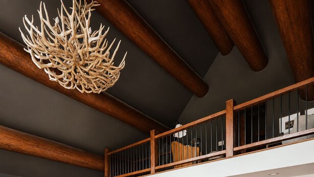 A spacious living area with a large sectional sofa, a dining table, and a staircase leading to an upper level. - Epic Views, Sauna, Dog Lovers 5BR, 25 min to Breck (Breckenridge)