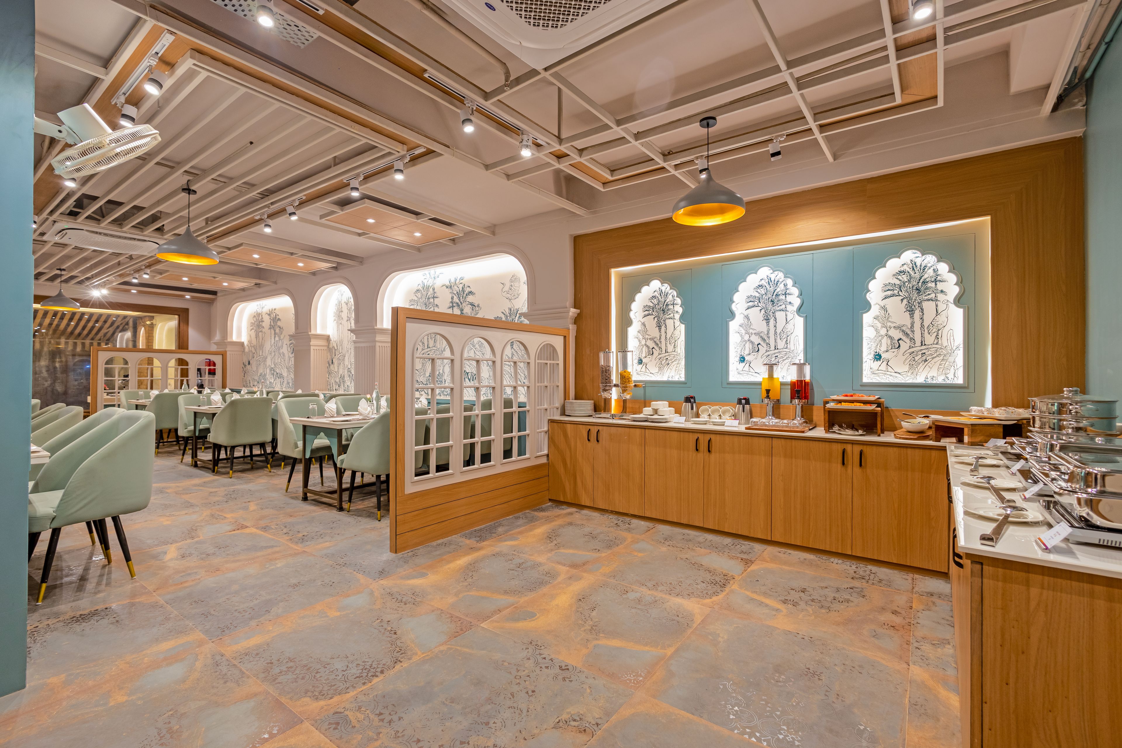 A restaurant with a modern interior, featuring a central wooden counter, multiple seating areas, and decorative wall art.