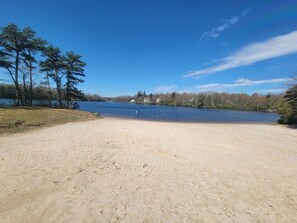 A sandy beach area with a lake and trees in the background. - Horizon Chalet Private Pool Hot Tub Pet Friendly (Long Pond)