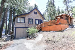 A two-story wooden house with a garage, a wooden deck, and a small porch. - All Seasons Chateau (Big Bear Lake)