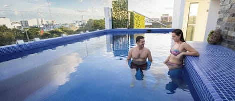 A swimming pool with a clear view of the cityscape in the background.