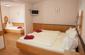A hotel room with two single beds, a television mounted on the wall, and a small picture on the wall. - Gasthof Roderich Hotel (Langenzersdorf)