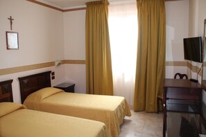 A hotel room with two beds, a desk, a television, and a cross on the wall. - Grand Hotel Degli Angeli (San Giovanni Rotondo)