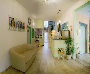A spacious living area with a sofa, a dining area with a table, and a kitchen in the background.