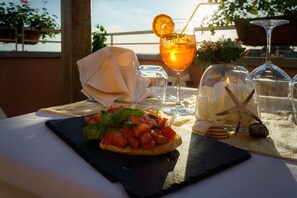 A table set with a meal, a drink, and decorative items.