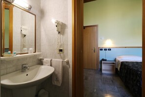 A bathroom with a sink, mirror, and hairdryer. - Hotel Sabo' (Argelato)