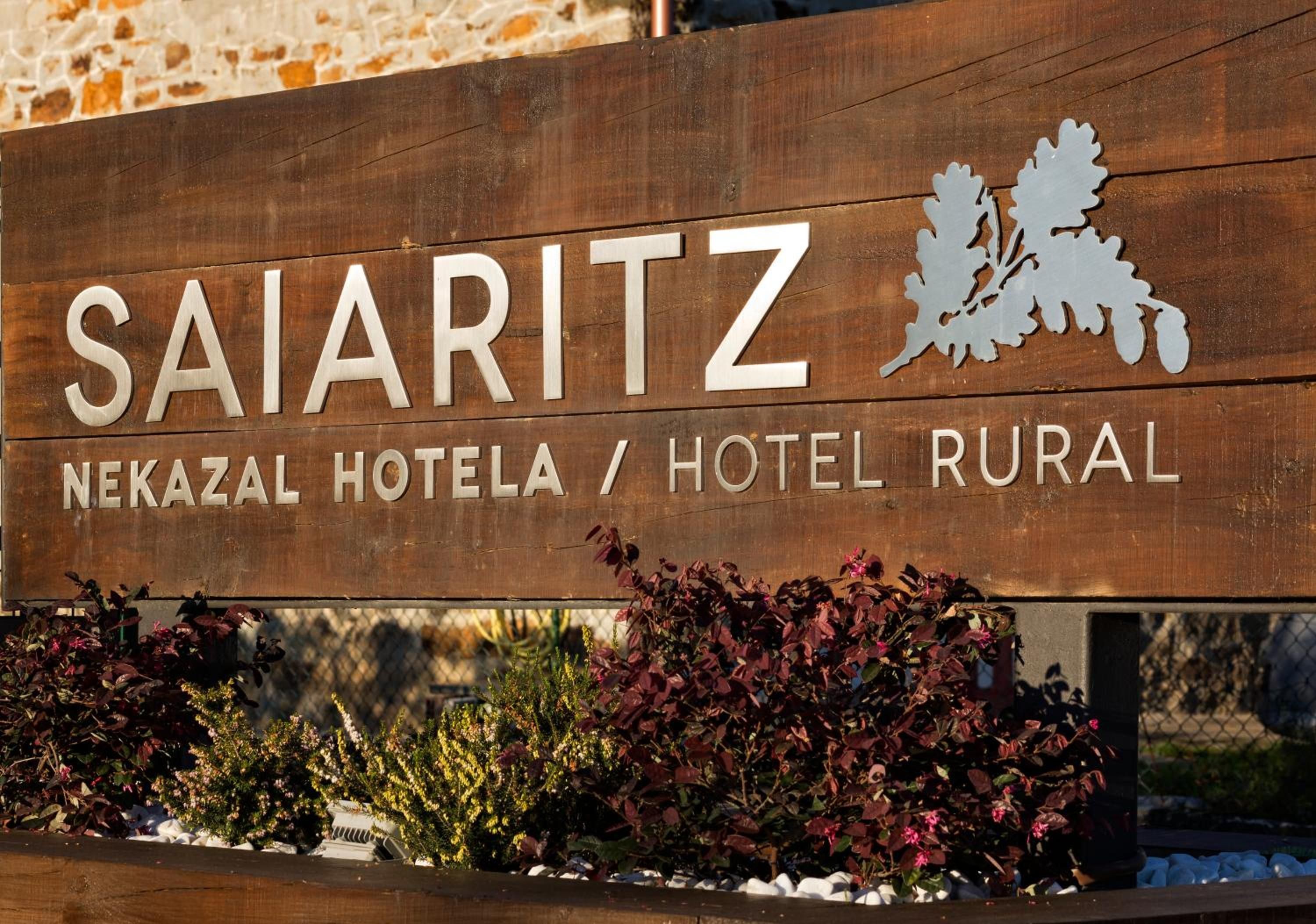 A wooden sign for SAIARITZ NEKAZAL HOTEL / HOTEL RURAL.