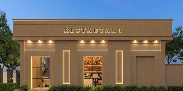 Un bâtiment moderne avec le mot « RESTAURANT » affiché en grand au-dessus de l’entrée.