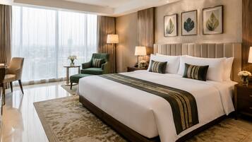 A hotel room with a large bed, a desk, a chair, a small side table, and a view of the city through the window.