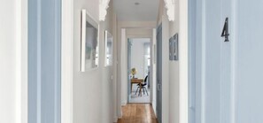 A hallway with a wooden floor, white walls, and a door marked with the number 4. - The Geelong West Gem (Greater Geelong)