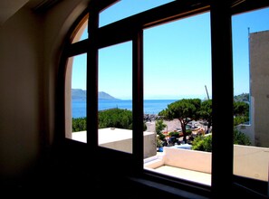 A view through a window with a clear sky and a distant coastline. - Hotel Santa Marina Antica Foresteria (Santa Marina Salina)