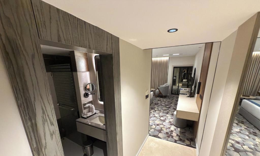 A modern bathroom with a shower, a toilet, and a sink.