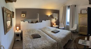 A hotel room with two beds, a nightstand, a lamp, a chair, a dresser, and a mirror. - La Gabetière (Estrablin)