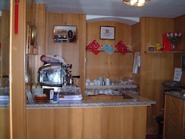 A kitchen with wooden cabinets, a coffee machine, and various kitchenware.