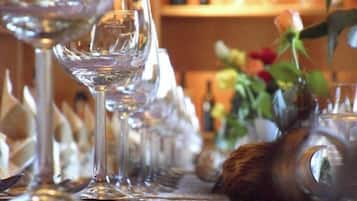 A row of empty wine glasses on a table.