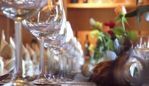 A row of empty wine glasses on a table.