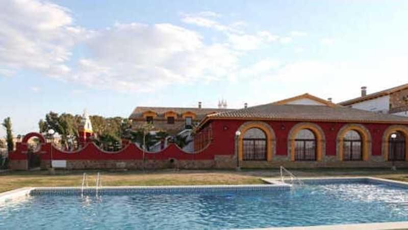 A swimming pool with a building in the background.