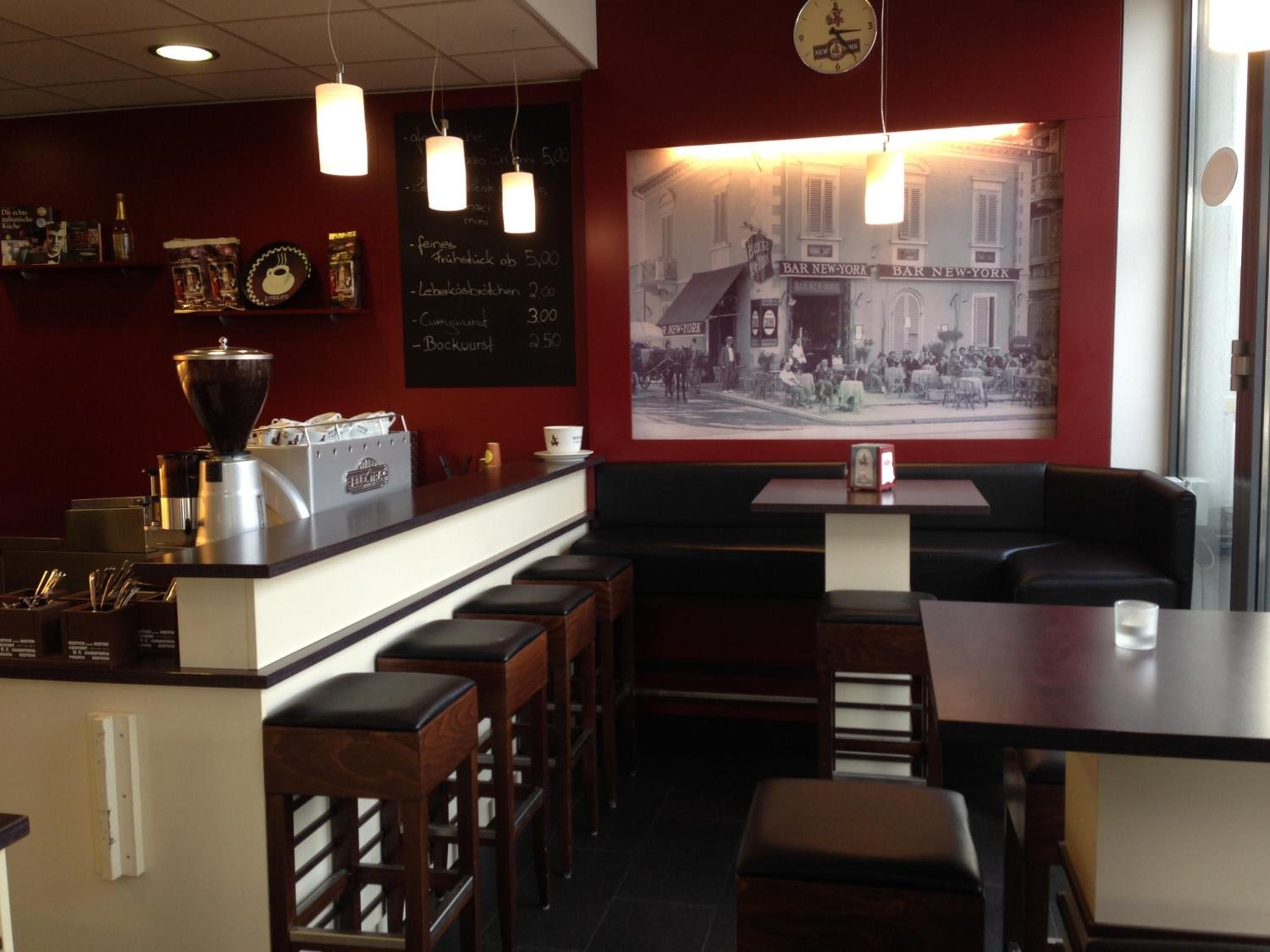 A bar with a counter, stools, and a vintage poster on the wall.