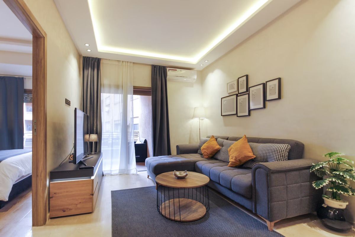 A modern living room with a sofa, a coffee table, and a television.