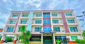 A multi-story hotel building with balconies, a prominent sign, and a covered entrance. - Al Ameen Hotel (Krabi)