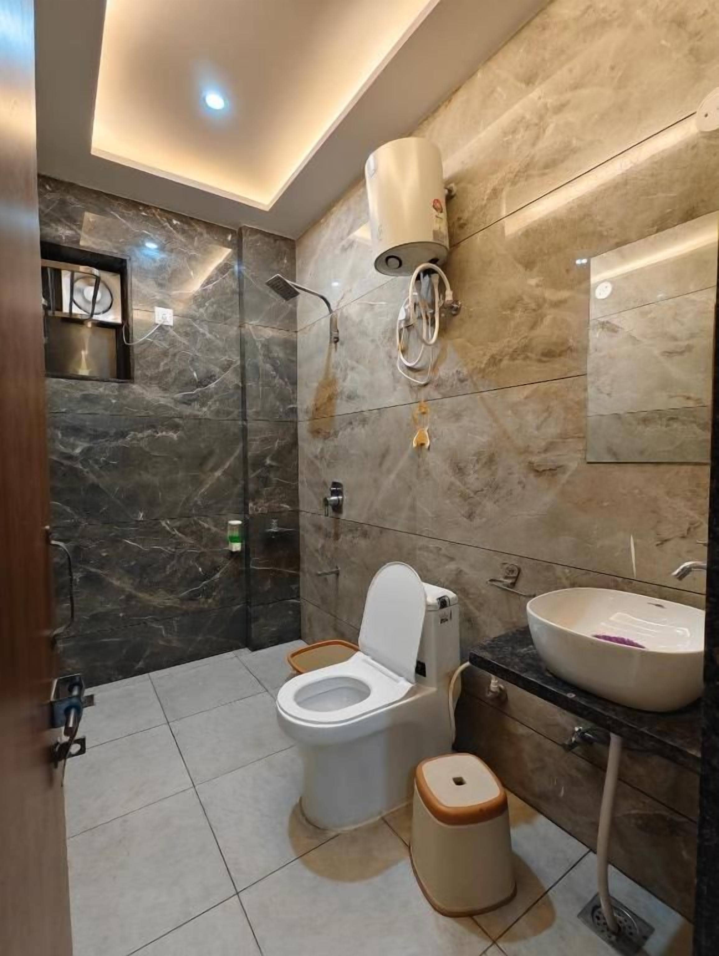 A modern bathroom with a toilet, bidet, and sink.