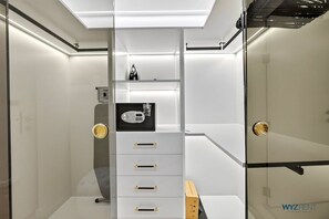 A modern bathroom with a glass shower enclosure, a built-in vanity with a mirror, and a toilet. - Full Burj Al Arab View 2BR • Private Sauna & Beach (Dubai)