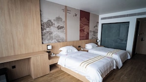 A hotel room with two beds, a desk, and a large window. - THE HAN HOTEL (Kathmandu)