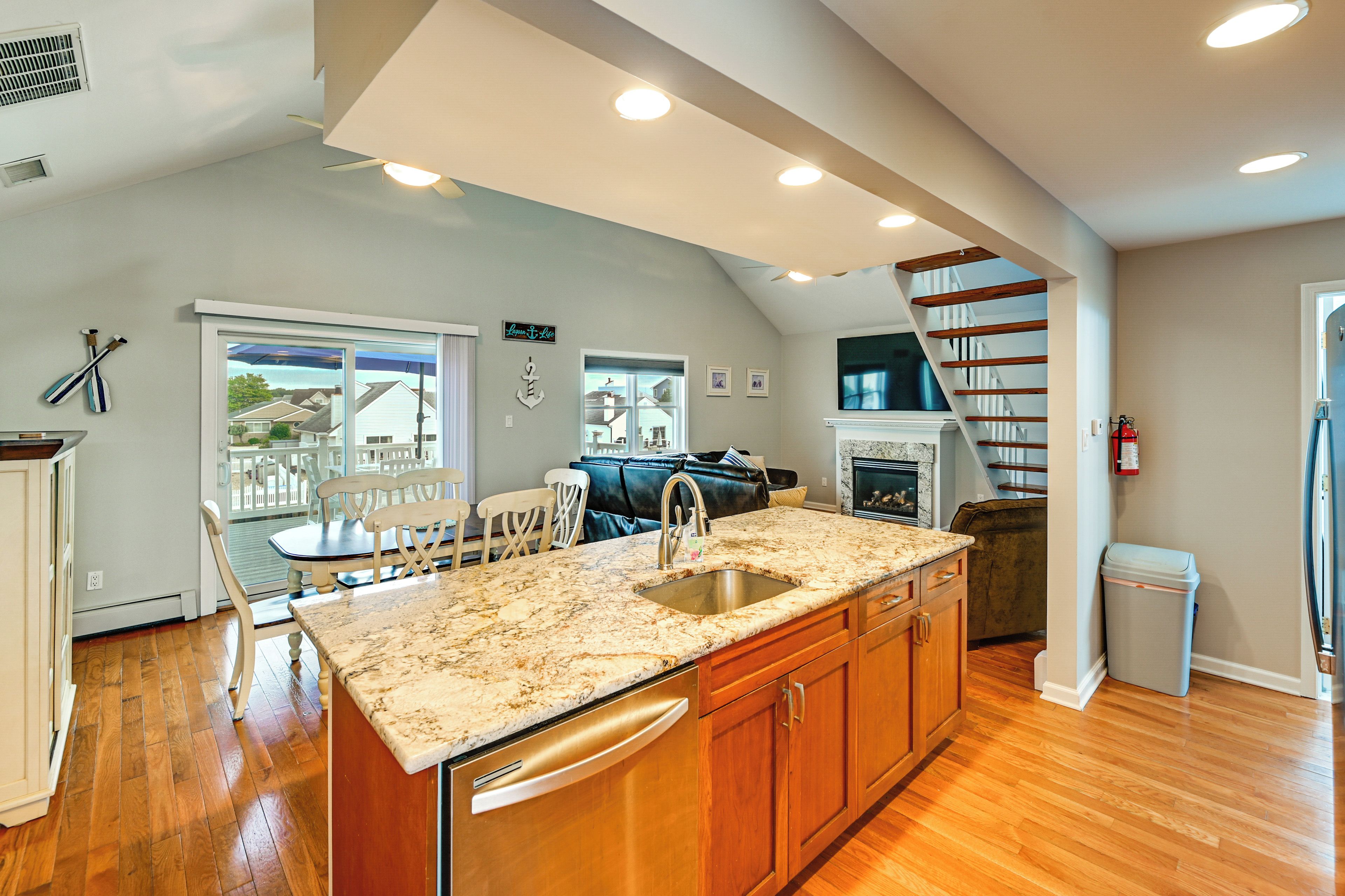 A kitchen with a large island, wooden cabinets, and a built-in oven.