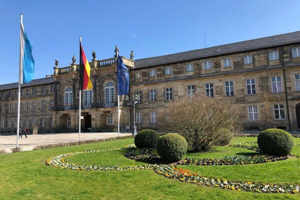 A historic building with a symmetrical facade, multiple windows, and a central entrance.