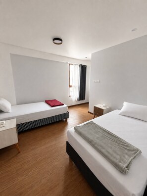 A hotel room with a bed, a smaller bed, a nightstand, a desk, and a window with curtains. - Urubamba 2 bedrooms, terraces and views (Urubamba)