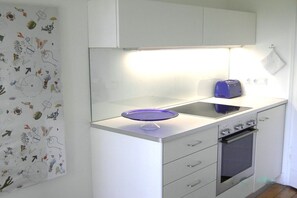 A kitchen with a white countertop, a toaster, and a blue dish on the sink. - 2 Alpenblick - Steineckhof (Schopfheim)