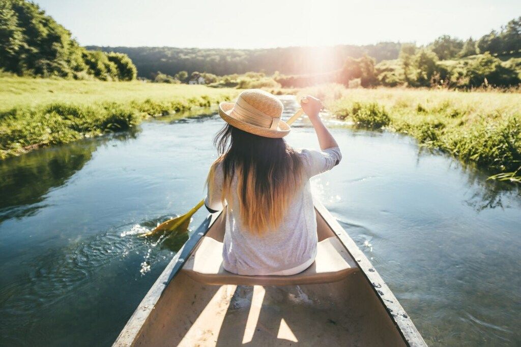 A person in a canoe on a river.