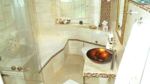 A bathroom with a bathtub, a sink with a vessel basin, and a shower area. - Holiday home in Remagen with swimming pool (Remagen)