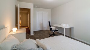 A bedroom with a bed, a desk, and a chair. - Near Highways & Hospitals! Extended Stay in Katy (Katy)