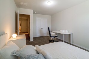 A bedroom with a bed, a desk, and a chair. - Near Highways & Hospitals! Extended Stay in Katy (Katy)