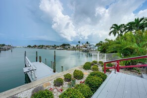 A marina with boats docked, a wooden dock, and a view of the water and distant buildings. - Bring Your Boat! Waterfront Clearwater Gem w/ Pool (Clearwater)