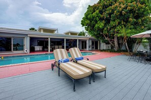 A poolside area with lounge chairs and a pool. - Bring Your Boat! Waterfront Clearwater Gem w/ Pool (Clearwater)