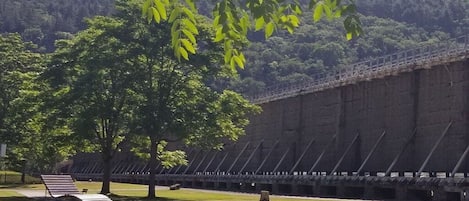 A large, open area with a long, straight wall and a pathway leading to a seating area.