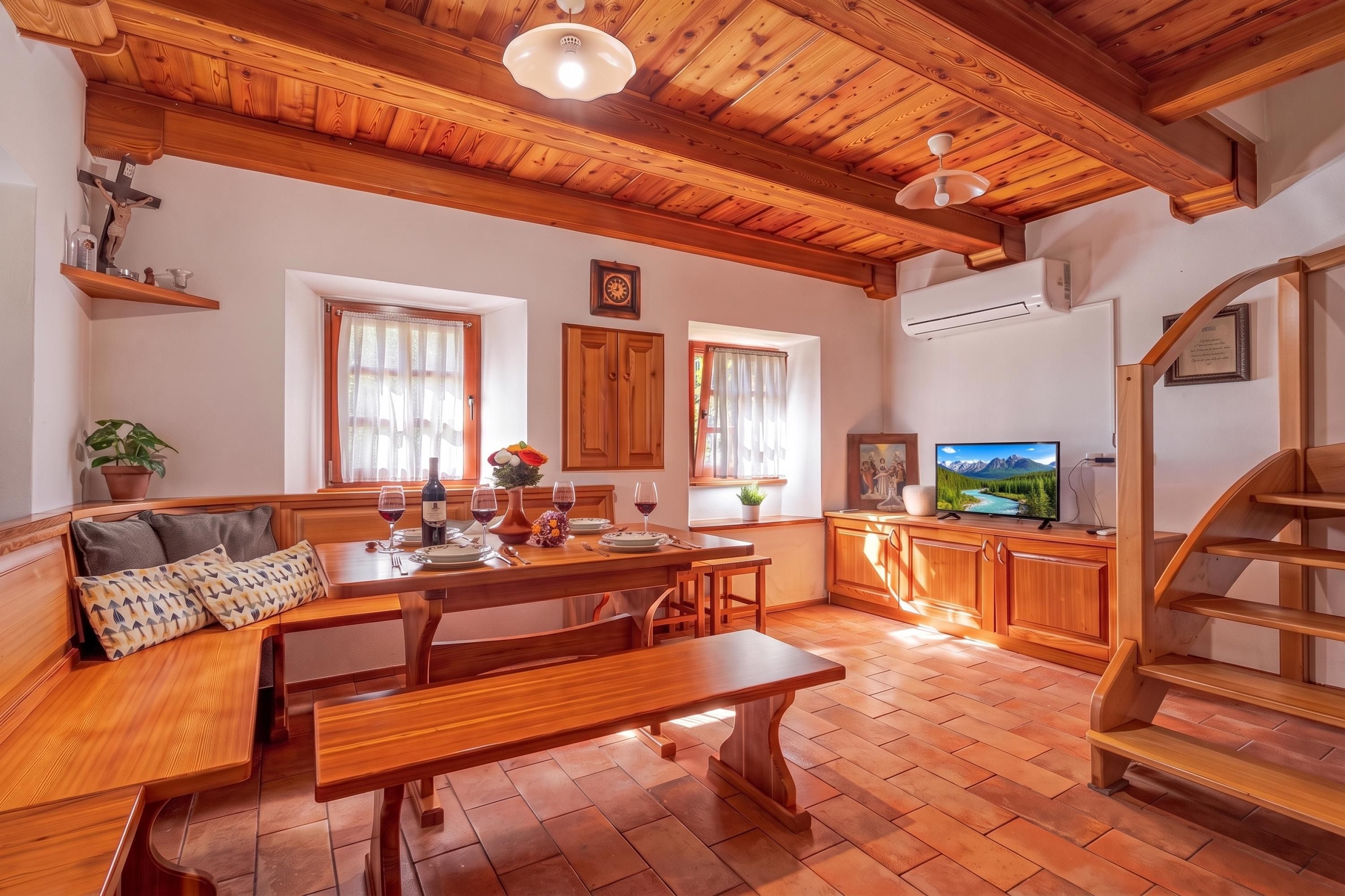 Un comedor acogedor con mobiliario de madera, un banco y una mesa preparada para una comida.