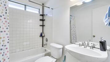 Un baño con bañera, inodoro y lavamanos.