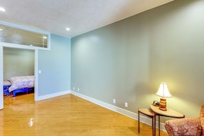 A room with a bed, a lamp, and a chair.