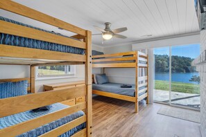 A bunk bed room with a view of a lake.